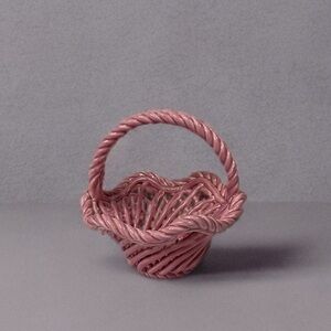 Vintage Italian pink ceramic basket with a woven, lattice-like design